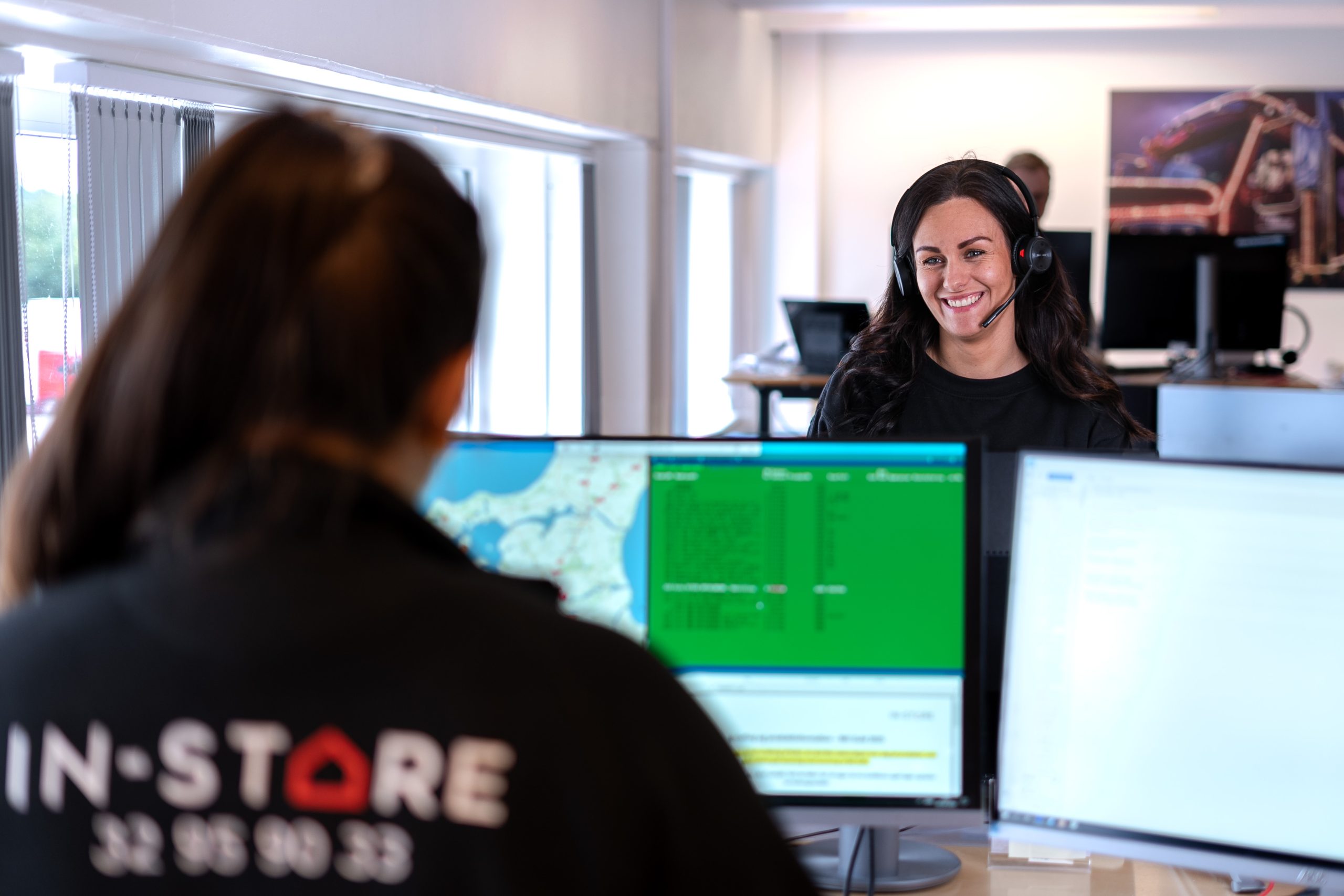 To kontormedarbejdere, der taler sammen